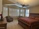 Spacious main bedroom featuring a bay window, plantation shutters, and a large ceiling fan at 18131 W Addie Ln, Surprise, AZ 85374