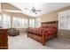 Spacious main bedroom features plantation shutters and a ceiling fan at 18131 W Addie Ln, Surprise, AZ 85374