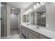 Bright bathroom featuring a double vanity with a modern walk-in shower at 1823 E Chelsea Ln # 106, Gilbert, AZ 85295