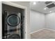 Stacked washer and dryer in a large laundry area with neutral walls at 1823 E Chelsea Ln # 106, Gilbert, AZ 85295