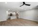 Inviting living area with an open layout to kitchen, hardwood floors, and a ceiling fan at 1823 E Chelsea Ln # 106, Gilbert, AZ 85295