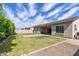 A well-manicured backyard features lush green grass, patio, and gravel areas, perfect for outdoor entertaining at 18929 W Windsor Blvd, Litchfield Park, AZ 85340