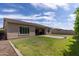 Expansive backyard featuring lush green grass, a paved patio, and a well-maintained exterior, perfect for outdoor enjoyment at 18929 W Windsor Blvd, Litchfield Park, AZ 85340