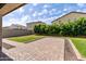View of the backyard's patio surrounded by green grass and landscaped gravel at 18929 W Windsor Blvd, Litchfield Park, AZ 85340
