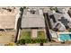 Aerial view of a backyard featuring a patio, small grass area, landscaping, and a pool at 18929 W Windsor Blvd, Litchfield Park, AZ 85340