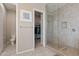 Bright bathroom featuring a shower, walk-in closet, and toilet at 18929 W Windsor Blvd, Litchfield Park, AZ 85340