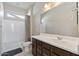 Well-lit bathroom with a large vanity, modern fixtures, and a shower-tub combination at 18929 W Windsor Blvd, Litchfield Park, AZ 85340
