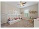 Cozy bedroom features a charming house frame bed, plush carpet, and ample natural light from the window at 18929 W Windsor Blvd, Litchfield Park, AZ 85340