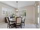 Dining area features a modern chandelier, neutral walls and lots of natural light at 18929 W Windsor Blvd, Litchfield Park, AZ 85340
