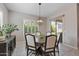 Dining area offers plantation shutters on the windows, access to the backyard, and neutral walls at 18929 W Windsor Blvd, Litchfield Park, AZ 85340