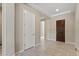 Hallway with tile floor, doors, and neutral paint at 18929 W Windsor Blvd, Litchfield Park, AZ 85340