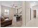 Home office featuring a built-in desk, shelves, and a comfortable couch at 18929 W Windsor Blvd, Litchfield Park, AZ 85340
