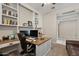 Home office featuring a built-in desk, shelves, and office chair at 18929 W Windsor Blvd, Litchfield Park, AZ 85340