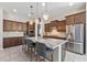 Modern kitchen featuring a large island, pendant lighting, and stainless appliances at 18929 W Windsor Blvd, Litchfield Park, AZ 85340
