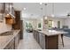 Open kitchen features stainless appliances, center island and adjoins the dining and living areas at 18929 W Windsor Blvd, Litchfield Park, AZ 85340
