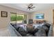 Comfortable living room with a plush sectional, TV, and backyard view at 18929 W Windsor Blvd, Litchfield Park, AZ 85340