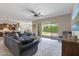 Open-concept living room with a large sectional and backyard access at 18929 W Windsor Blvd, Litchfield Park, AZ 85340
