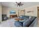 Spacious living room with a ceiling fan, TV, and stylish decor at 18929 W Windsor Blvd, Litchfield Park, AZ 85340