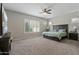 The primary bedroom is spacious with plantation shutters, neutral walls and carpet at 18929 W Windsor Blvd, Litchfield Park, AZ 85340
