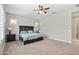 Main bedroom features plush carpeting, plantation shutters, a ceiling fan, and neutral walls at 18929 W Windsor Blvd, Litchfield Park, AZ 85340