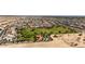 Aerial view of a neighborhood with a park, highlighting the community's layout and proximity to a desert landscape at 18929 W Windsor Blvd, Litchfield Park, AZ 85340