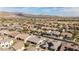 An aerial view of a neighborhood showcasing well-maintained homes against a backdrop of scenic mountains and blue skies at 18929 W Windsor Blvd, Litchfield Park, AZ 85340