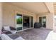 The outdoor patio has comfortable chairs, a grill, and opens to the home's interior at 18929 W Windsor Blvd, Litchfield Park, AZ 85340