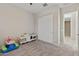 Inviting playroom with carpet, storage, and closet offers plenty of space for fun and organization at 18929 W Windsor Blvd, Litchfield Park, AZ 85340