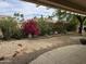 Backyard with lush landscaping, colorful flowers, and decorative stone edging for a tranquil outdoor setting at 19139 N Alameda Dr, Surprise, AZ 85387