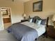 Cozy bedroom with a comfortable bed, warm lighting, and an ensuite bathroom view at 19139 N Alameda Dr, Surprise, AZ 85387