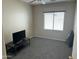 Simple bedroom with neutral walls, a large window, and gray carpet at 19139 N Alameda Dr, Surprise, AZ 85387