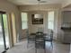 Bright dining area with a glass table, modern chairs, and sliding glass doors to the outside at 19139 N Alameda Dr, Surprise, AZ 85387