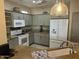 Bright kitchen featuring granite countertops, light-colored cabinets, tile floors, and white appliances at 19139 N Alameda Dr, Surprise, AZ 85387