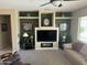 Cozy living room with a decorative fireplace, built-in shelving, and comfortable seating at 19139 N Alameda Dr, Surprise, AZ 85387