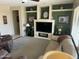 Inviting living room with plush seating, built-in shelving, and a modern fireplace design at 19139 N Alameda Dr, Surprise, AZ 85387