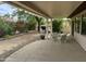 Relaxing covered patio with well-maintained landscaping and a dining area for outdoor enjoyment at 19139 N Alameda Dr, Surprise, AZ 85387