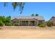 Exterior view of a house with a desert landscaped yard and covered patio at 19892 N Shadow Mountain Dr, Surprise, AZ 85374