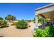 Backyard view showcasing desert landscaping, mature landscaping and a covered patio at 19892 N Shadow Mountain Dr, Surprise, AZ 85374