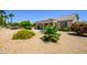 A beautiful backyard featuring mature landscaping, desert landscaping and a covered patio at 19892 N Shadow Mountain Dr, Surprise, AZ 85374
