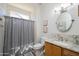 Well-lit bathroom featuring a single sink vanity, a framed mirror and a shower with a curtain at 19892 N Shadow Mountain Dr, Surprise, AZ 85374