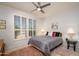Cozy bedroom featuring neutral color scheme, shuttered windows, a ceiling fan, and plush pink rug at 19892 N Shadow Mountain Dr, Surprise, AZ 85374
