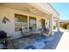 Inviting covered patio with ceiling fan and comfortable seating, ideal for outdoor relaxation and entertaining at 19892 N Shadow Mountain Dr, Surprise, AZ 85374