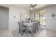 Bright dining area with stylish chairs, a glass top table, and sliding doors that let in plenty of light at 19892 N Shadow Mountain Dr, Surprise, AZ 85374