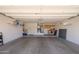 Spacious two car garage with ample room for parking and storage, featuring utility sink and cabinets at 19892 N Shadow Mountain Dr, Surprise, AZ 85374
