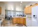 Spacious kitchen with granite countertops, wood cabinets, and an open view to the living area at 19892 N Shadow Mountain Dr, Surprise, AZ 85374