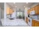 Open kitchen with granite countertops, light wood cabinetry, and modern white appliances at 19892 N Shadow Mountain Dr, Surprise, AZ 85374