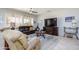 Inviting living space showcasing tile floors, plush seating, and an entertainment center with a television at 19892 N Shadow Mountain Dr, Surprise, AZ 85374