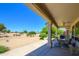 Charming covered patio seating area overlooks well-maintained desert landscape and expansive views at 19892 N Shadow Mountain Dr, Surprise, AZ 85374