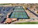 Aerial view of outdoor pickleball courts surrounded by a parking lot, desert landscaping, and nearby homes at 19892 N Shadow Mountain Dr, Surprise, AZ 85374