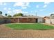 A backyard with a small patch of grass surrounded by decorative rock at 2015 W Weldon Ave, Phoenix, AZ 85015